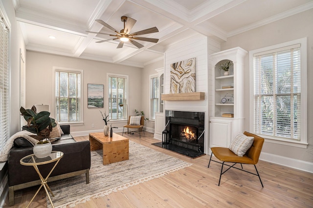 82 Ponsbury Rd, Mount Pleasant, SC 29464 - living area with a warm lit fireplace, wood finished floors, beamed ceiling, coffered ceiling, and baseboards