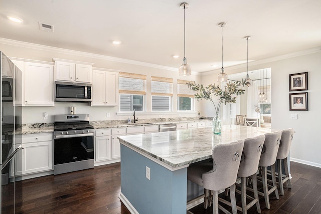 121 Cherry Grv, Summerville, SC 29483 - kitchen featuring stainless steel appliances, a sink, dark wood-style flooring, ornamental molding, and white cabinetry