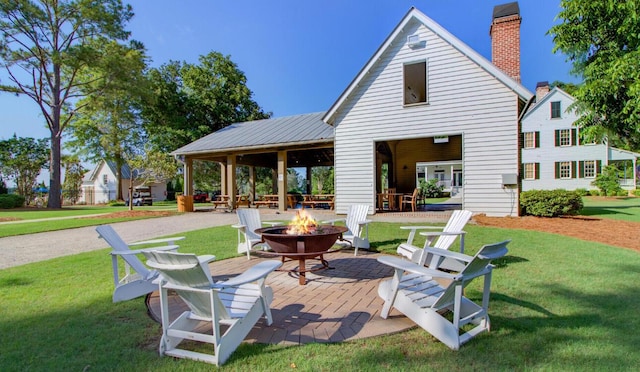 121 Cherry Grv, Summerville, SC 29483 - rear view of property with an outdoor fire pit, a lawn, a patio, and a chimney