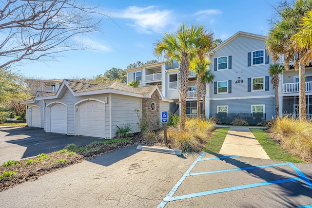 townhome / multi-family property featuring a residential view and a garage