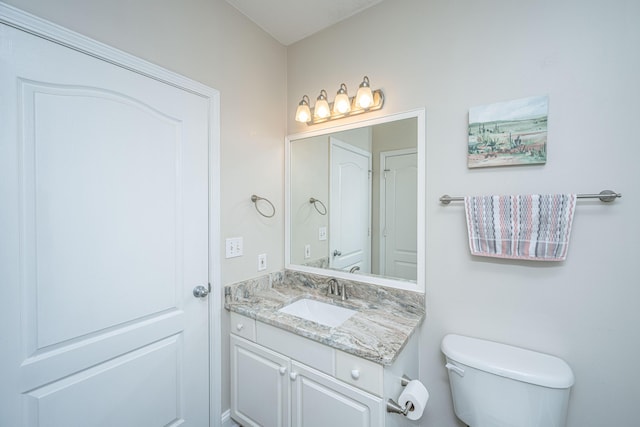 bathroom featuring toilet and vanity