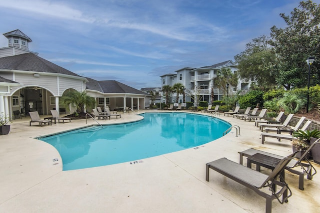 pool featuring a residential view and a patio