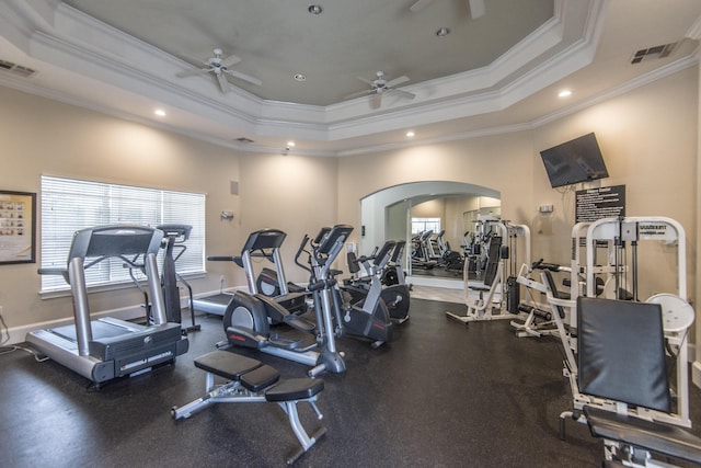 workout area featuring a tray ceiling and visible vents