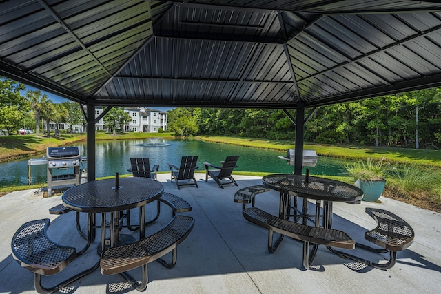 view of patio / terrace with a gazebo, a grill, and a water view