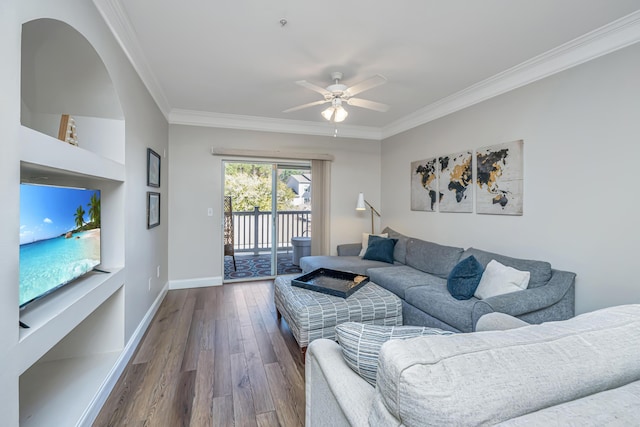 living room with baseboards, crown molding, a ceiling fan, and dark wood-style flooring