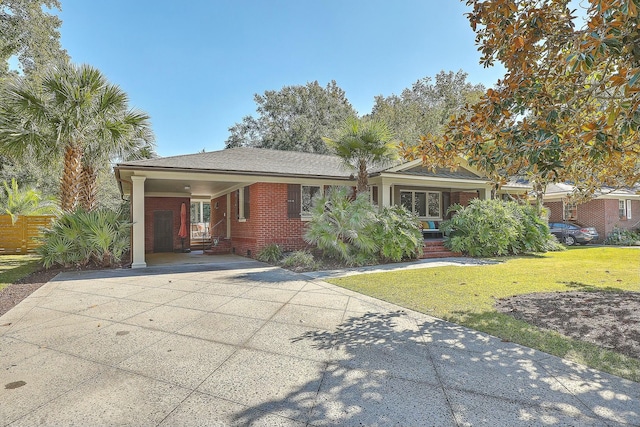 single story home with a front lawn and a carport