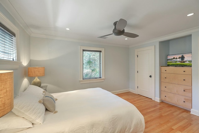 bedroom featuring light wood-type flooring, ceiling fan, and crown molding