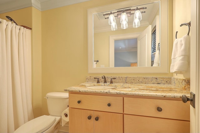 bathroom featuring toilet, ornamental molding, and vanity