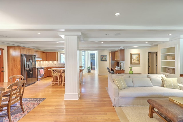 living room with beam ceiling, light wood-type flooring, and built in features