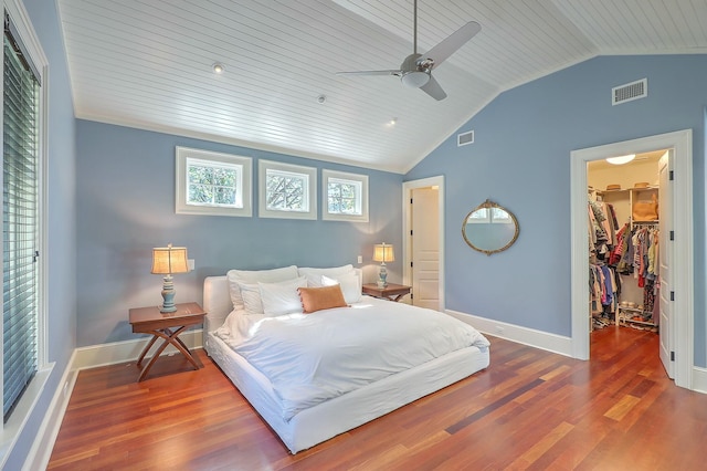 bedroom with a spacious closet, lofted ceiling, wood ceiling, a closet, and ceiling fan