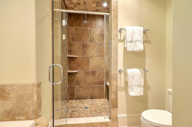 bathroom with toilet and an enclosed shower