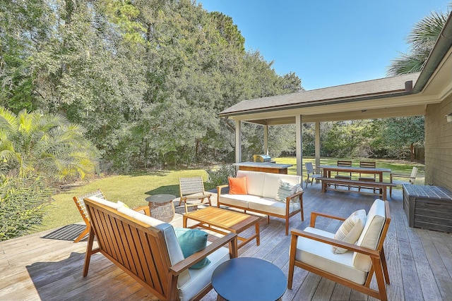 wooden deck with outdoor lounge area and a lawn