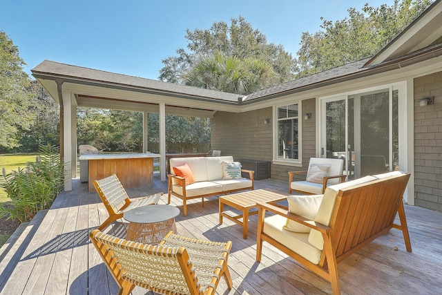 wooden deck featuring outdoor lounge area and a hot tub