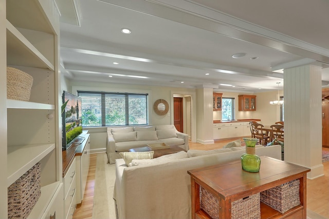 living room featuring beamed ceiling and light wood-type flooring