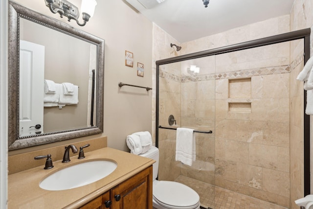 bathroom featuring vanity, toilet, and walk in shower