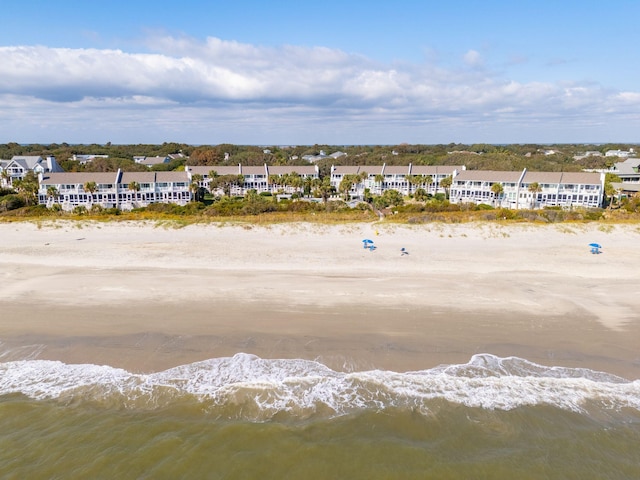 birds eye view of property featuring a water view and a beach view