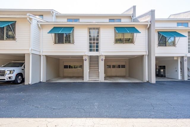 multi unit property featuring a garage and a carport