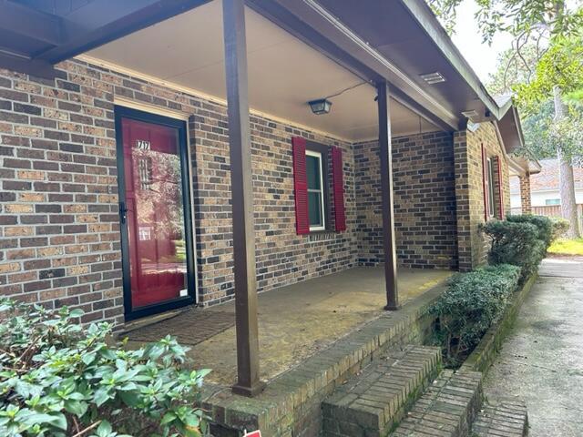 entrance to property with brick siding