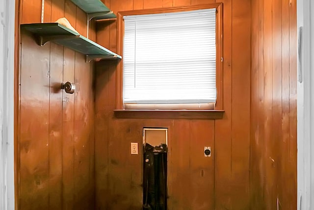 washroom with hookup for an electric dryer and wooden walls