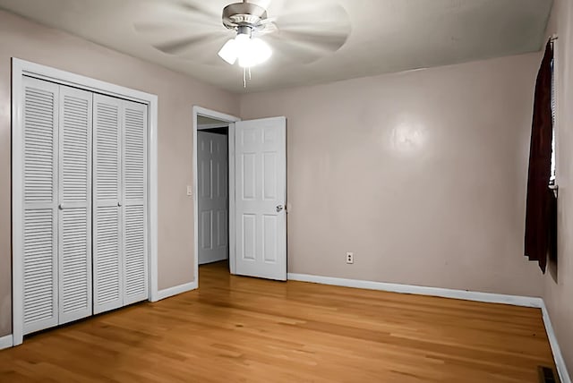 unfurnished bedroom featuring a closet, light wood-type flooring, and ceiling fan