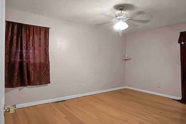 spare room with hardwood / wood-style flooring and ceiling fan