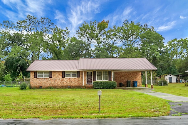 ranch-style home with a front lawn, a shed, and a carport