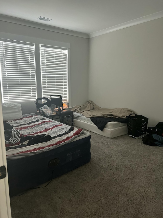 carpeted bedroom featuring ornamental molding