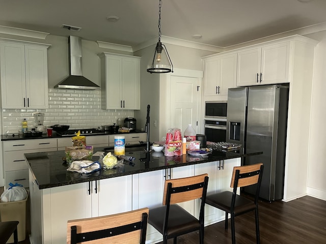 kitchen with appliances with stainless steel finishes, backsplash, ornamental molding, dark wood-type flooring, and wall chimney range hood