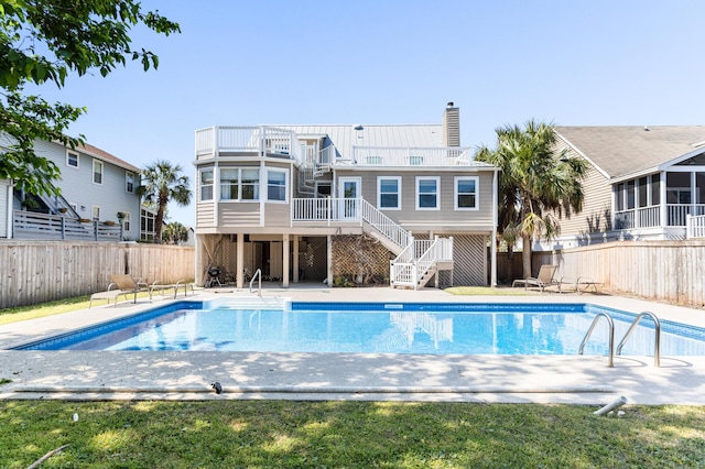 view of swimming pool featuring stairway, a fenced backyard, and a fenced in pool