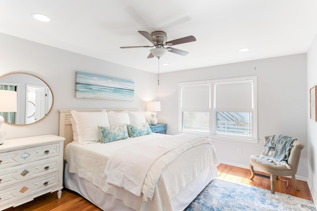 bedroom with wood finished floors, recessed lighting, and baseboards