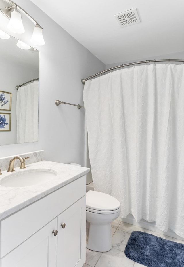 full bathroom featuring vanity, visible vents, toilet, and marble finish floor