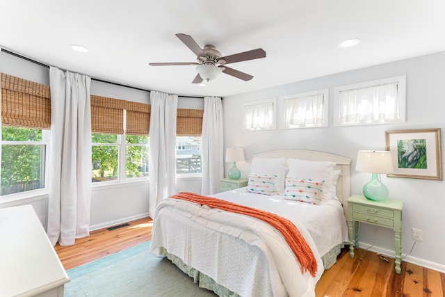 bedroom featuring visible vents, baseboards, recessed lighting, wood finished floors, and a ceiling fan