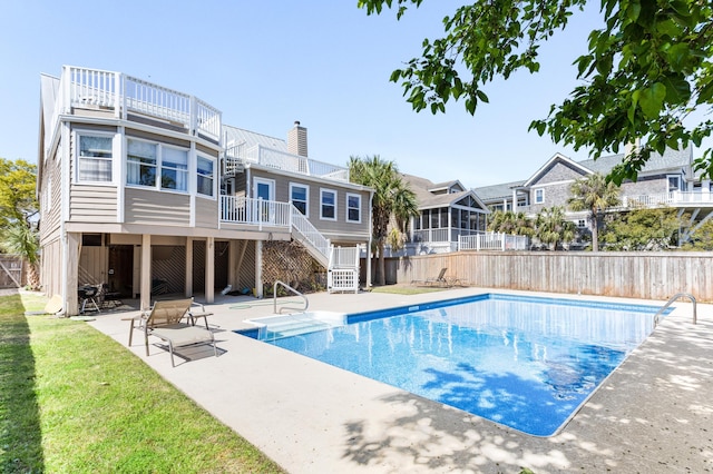 view of pool with a patio, a fenced in pool, stairway, and fence