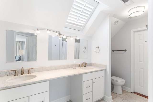 bathroom with double vanity, toilet, lofted ceiling, and tile patterned floors