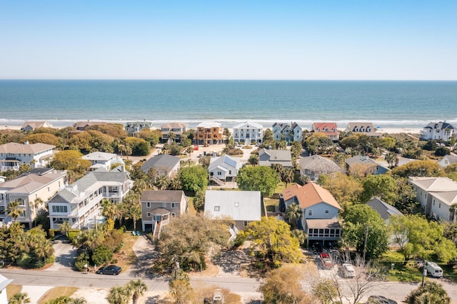 drone / aerial view with a view of the beach, a residential view, and a water view