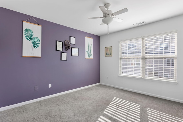 carpeted empty room with ceiling fan