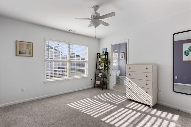 unfurnished bedroom with connected bathroom, ceiling fan, and carpet