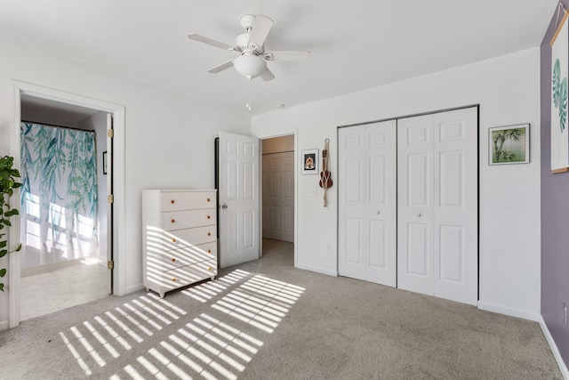 unfurnished bedroom with ceiling fan, light colored carpet, and a closet