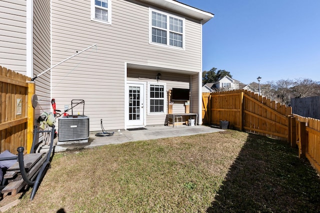 back of house featuring a lawn, a patio area, and central air condition unit