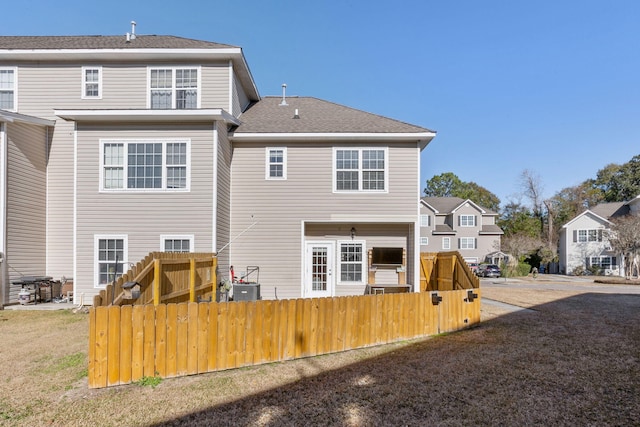 back of property featuring central AC