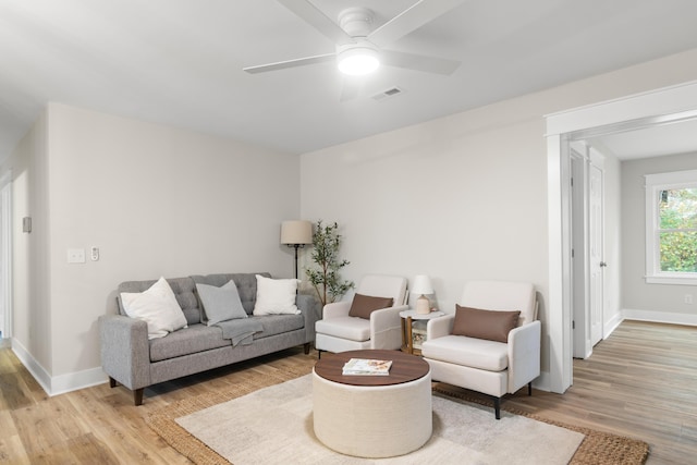 living room featuring ceiling fan and light hardwood / wood-style floors