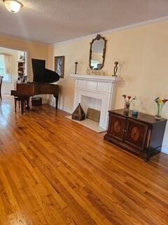1 Mcclary St, Summerton, SC 29148 - living area with wood finished floors, a fireplace with flush hearth, and crown molding