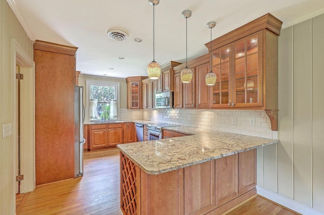 17 Johnson Rd, Charleston, SC 29407 - kitchen featuring appliances with stainless steel finishes, brown cabinets, a peninsula, light wood-style flooring, and ornamental molding