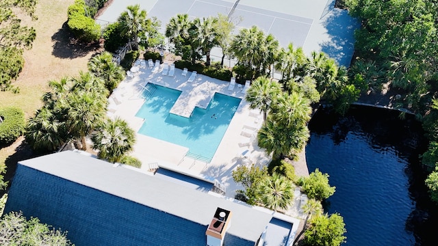 view of subject property featuring a pool area and a large body of water