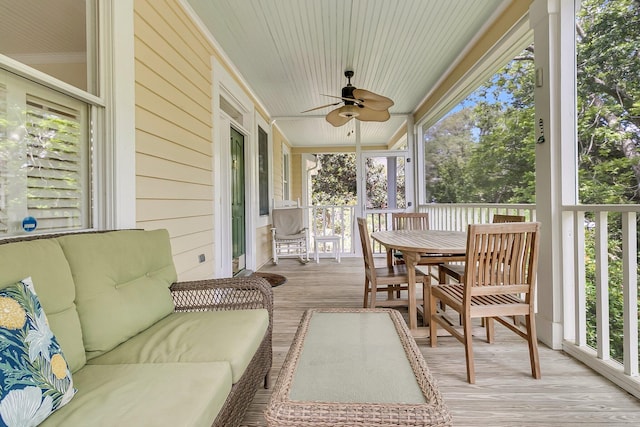 sunroom with ceiling fan, outdoor dining space, and an outdoor living space