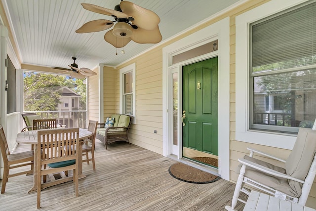doorway to property featuring a ceiling fan and a porch