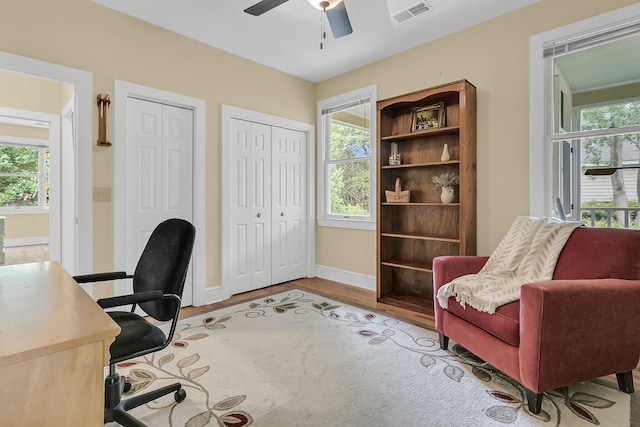 office area featuring baseboards, a ceiling fan, and wood finished floors