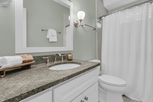 bathroom with toilet, vanity, and curtained shower