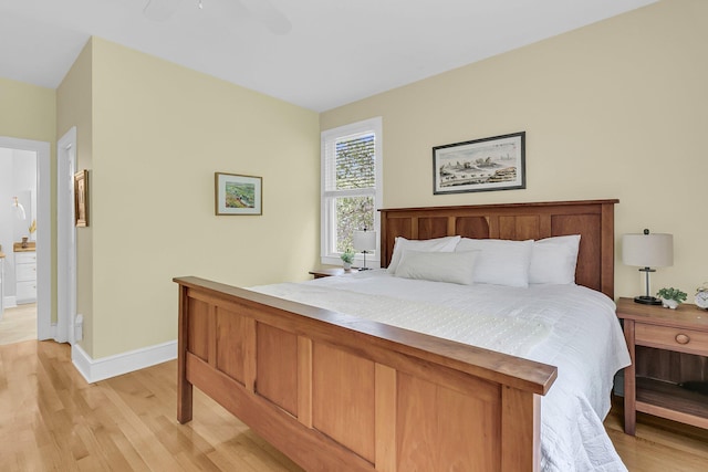 bedroom with light wood finished floors, baseboards, and a ceiling fan