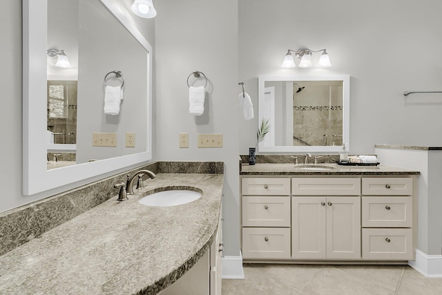 bathroom with a shower stall, tile patterned flooring, and two vanities